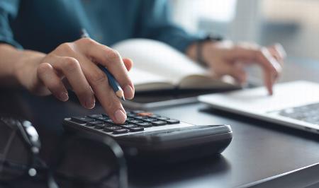 lady working out costs on calculator